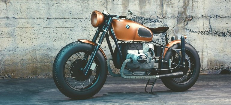 Retro-style BMW motorcycle parked against a concrete wall, capturing classic design and rugged appeal.
