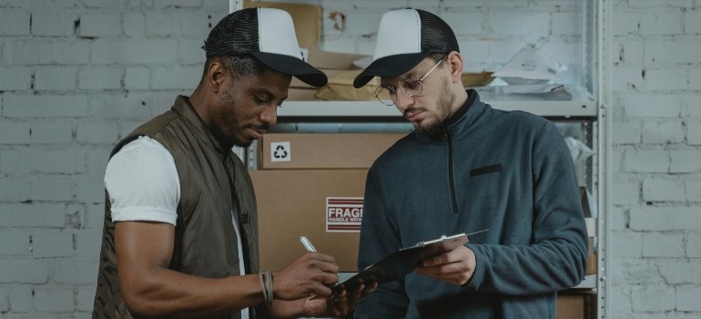 A man is signing the contract about storage space in Queens.