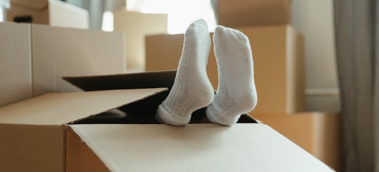 A person lying inside of a box.