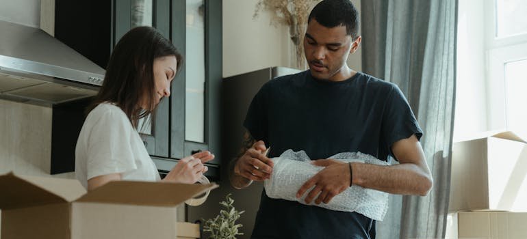 A couple packing their items.