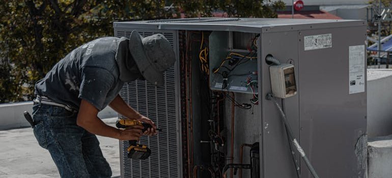 A repairman maintaining the AC.