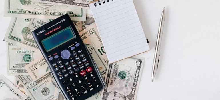 calculator on top of a pile of cash