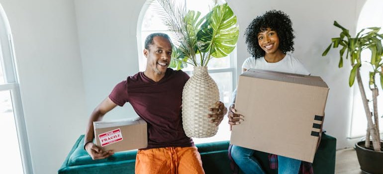 Movers holding items that are ready for the move because local moves still need a solid packing strategy.