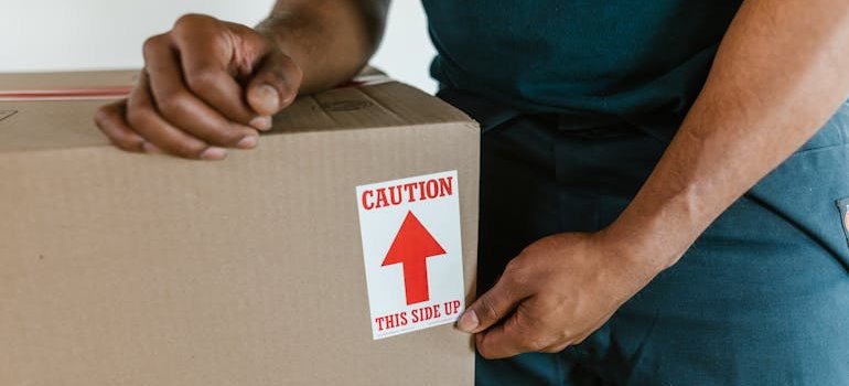A mover labeling a box because local moves still need a solid packing strategy.