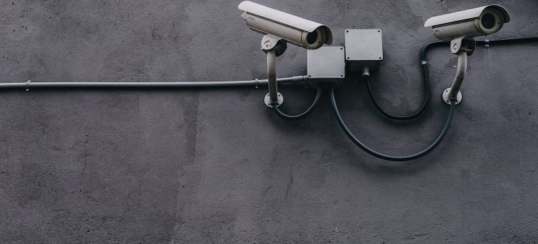White cameras on the gray wall.