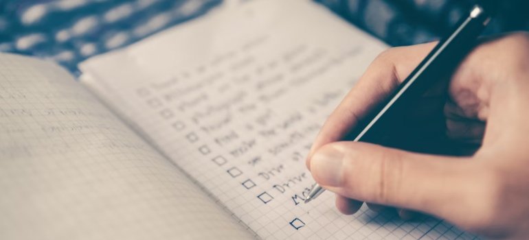 A person writing on a checklist