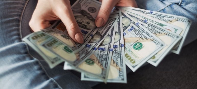 A person holding a fan of money