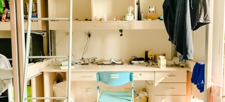 A small student corner with a chair, a desk and student supplies such as for NYC teens moving out for college