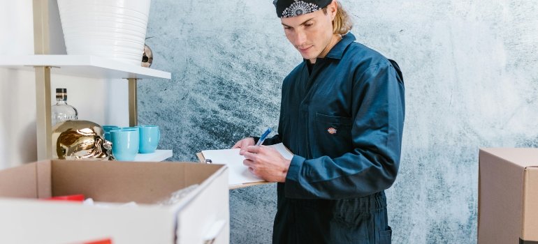 a man ensuring all benefits of storage companies that offer pickup services are met