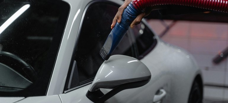 A man is cleaning his car before long-term storage.