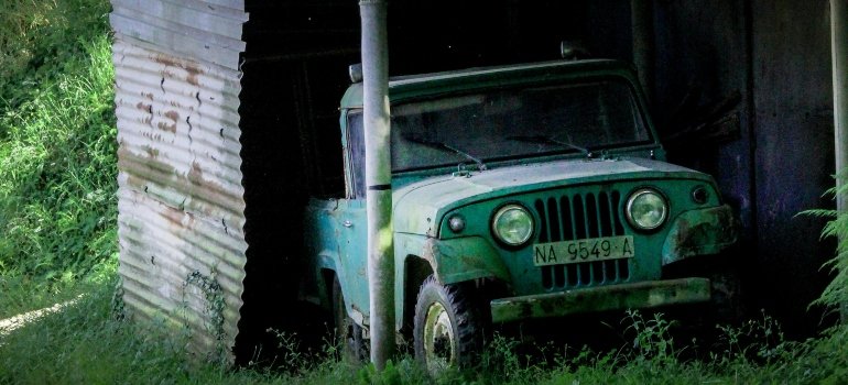 An abandoned car under the eaves.