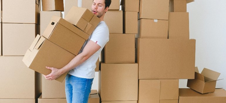 a man holding extensive boxes