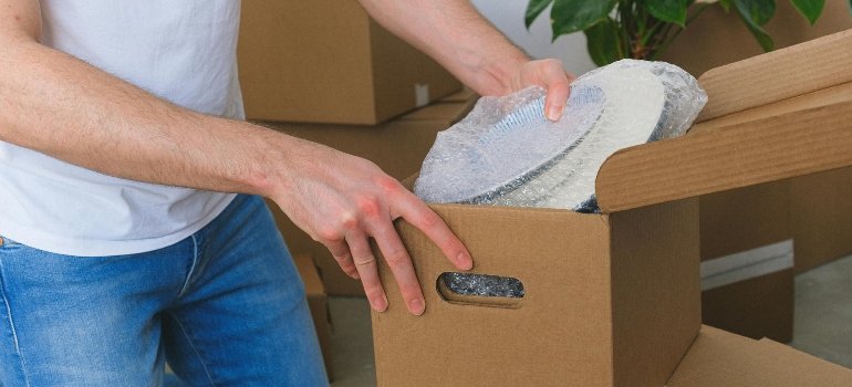 packing plates in a box not thinking about what to do if your items get damaged in storage