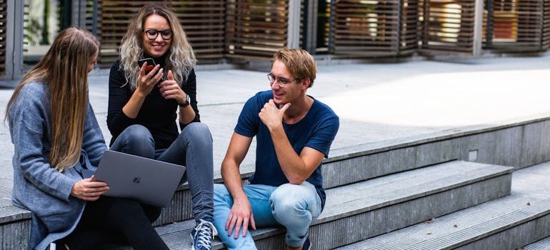students siting on the pavement