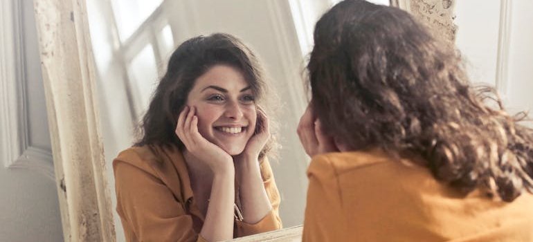 a person looking themselves in the mirror