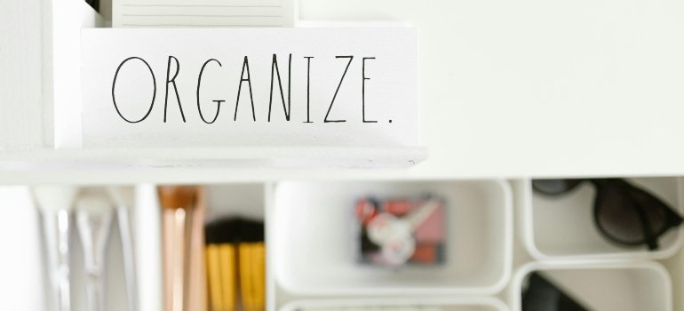 Storage drawer labeled "Organize" with neat compartments—ideal for when you need storage when moving in with a roommate.