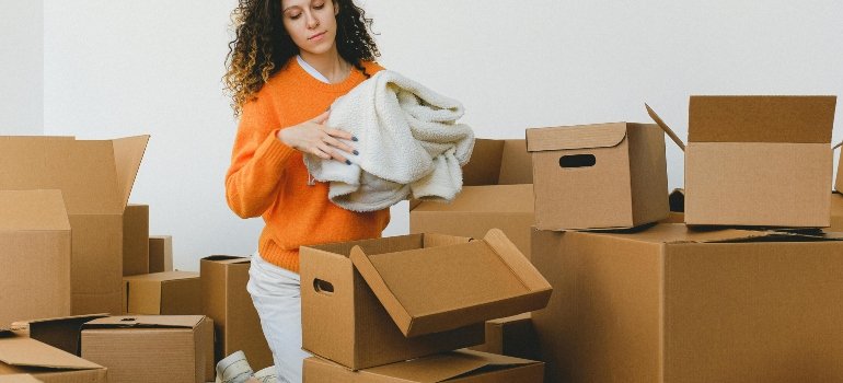 a girl packing boxes