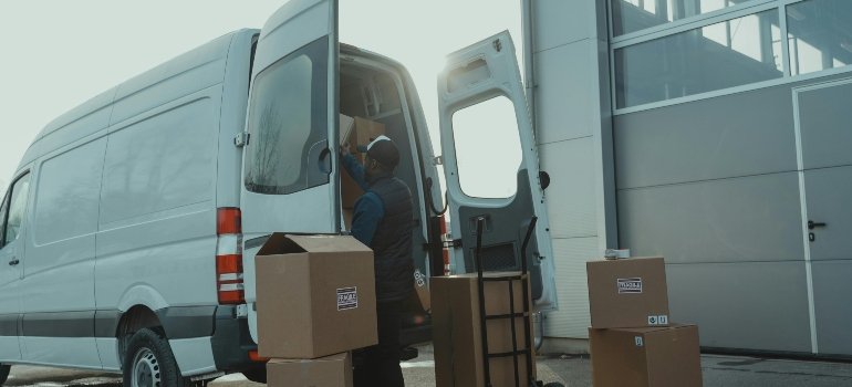 A man packing van as one of things to consider while choosing a storage company