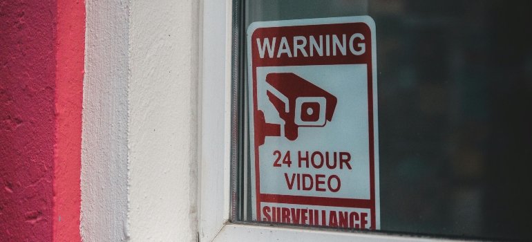 Signboard video surveillance placed on window in daytime