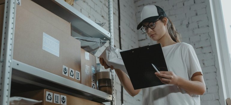 a girl checking the list of boxes