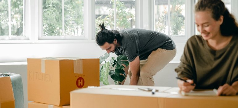 a boy and a girl packing boxes