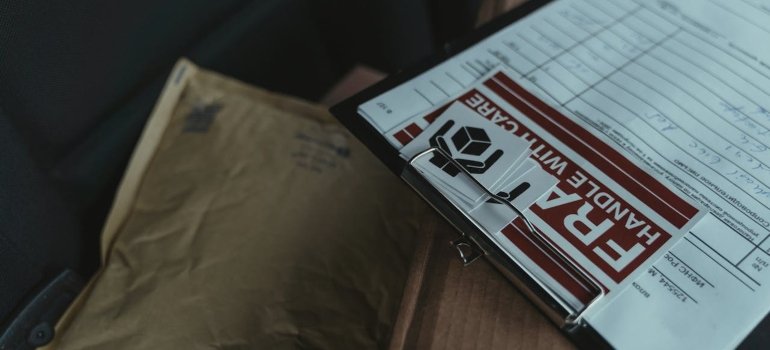 A clipboard with a fragile shipping label and a storage checklist for new homeowners