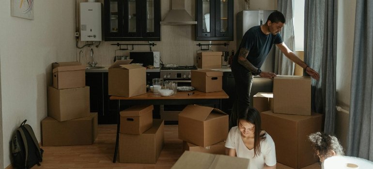 Parents packing kitchen boxes