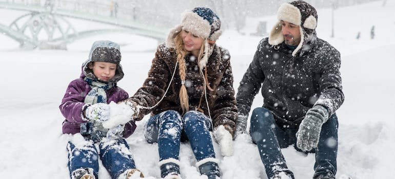 A family sitting on the snow
