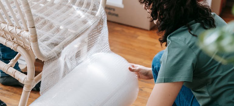 A woman packing a chair