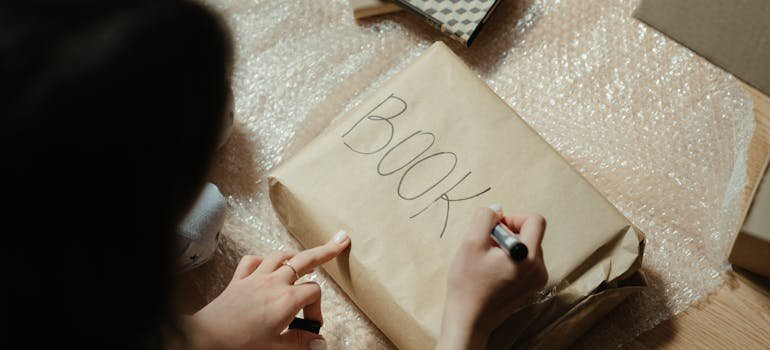 A woman labeling a package