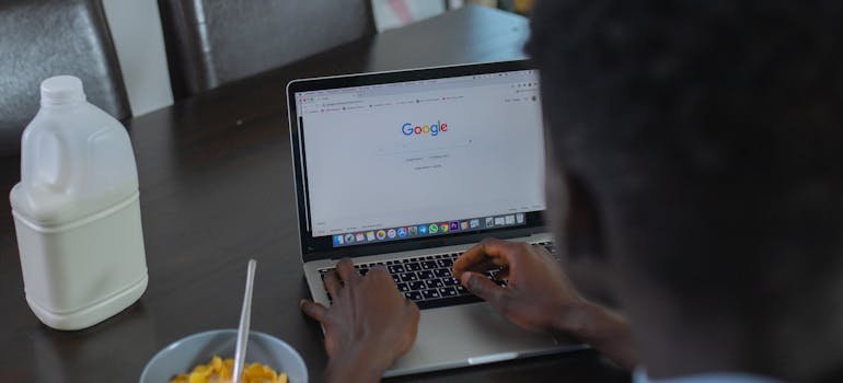 A person using laptop to research the hidden costs of renting storage in NYC