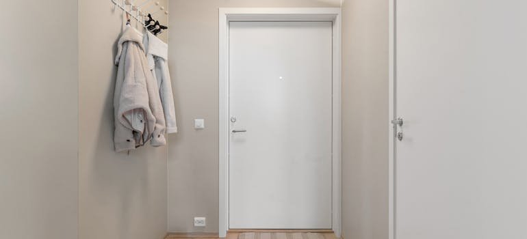 Hooks on the wall showing how to organize your closet in a Manhattan apartment
