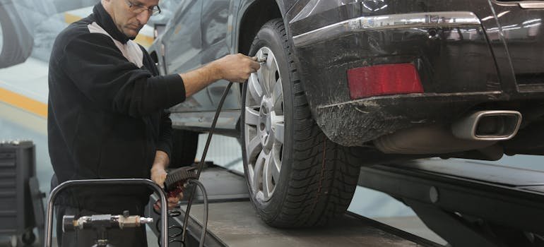 A man checking tire pressure and trying to prepare your car for winter storage in New York City