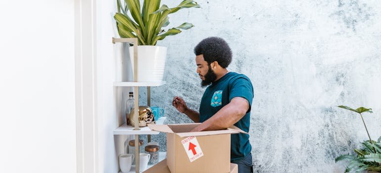 A person packing a moving box