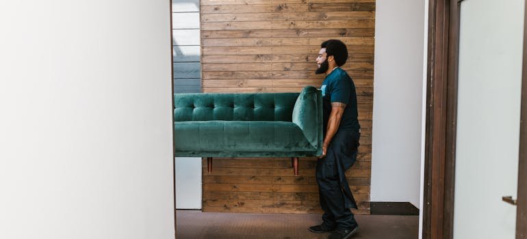 A mover holding a sofa