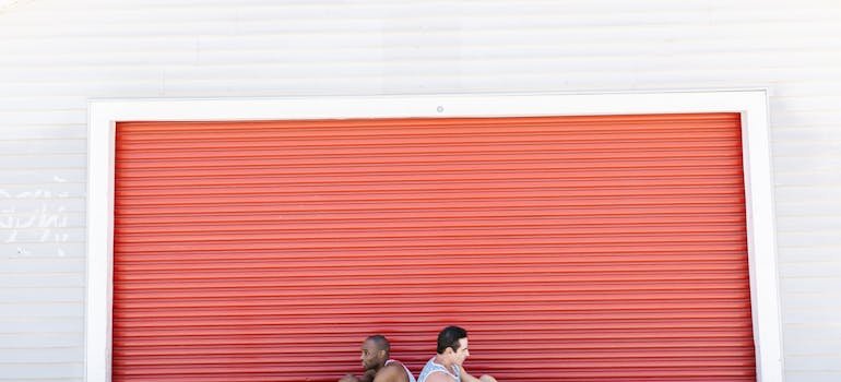 Two people in front of the storage unit