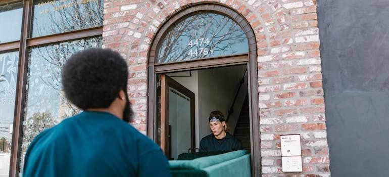 Movers carrying sofa