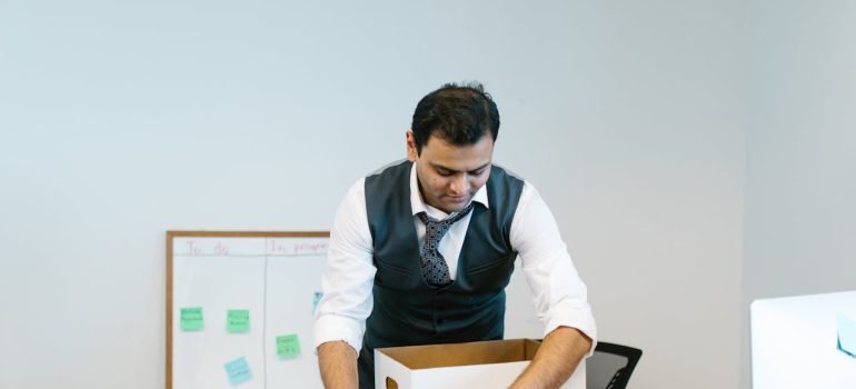 A man packing office equipment
