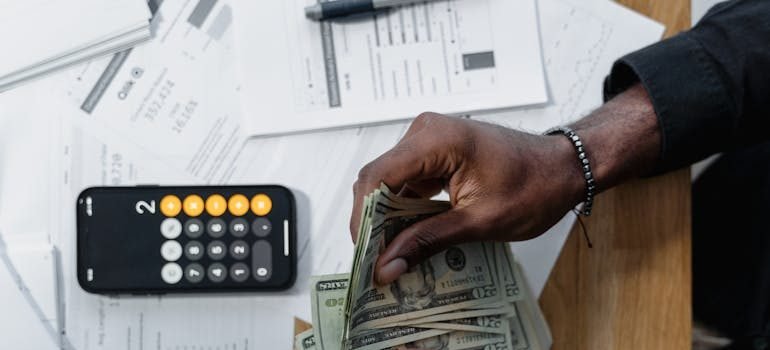 A woman counting dollar bills