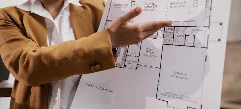 A woman holding a floor plan