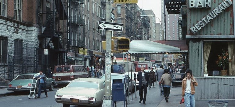 A person walking on the street adjusting to Manhattan life after moving from a suburb
