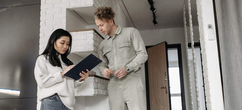 A man and a woman looking at the NYC apartment renovation guide