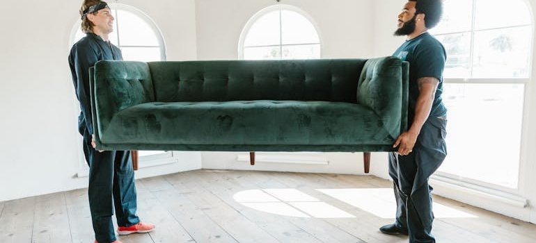 Two men holding sofa