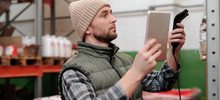A person in the warehouse taking inventory