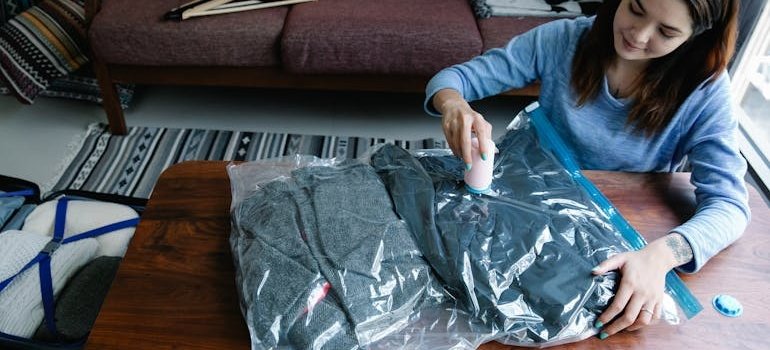 A person using a vacuum bag for packing