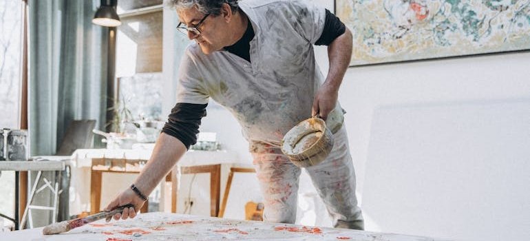 A man painting on the canvas
