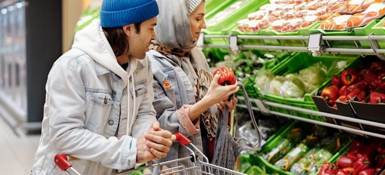 A couple doing groceries in one of the budget-friendly Bronx areas for renters