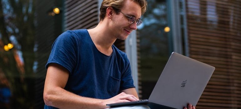 A man using laptop to research living in the Bronx as a student