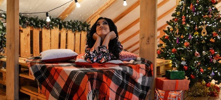 A woman next to the Christmas tree