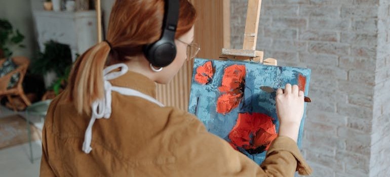An artisit painting at home and thinking how NYC artists can use storage for large canvases